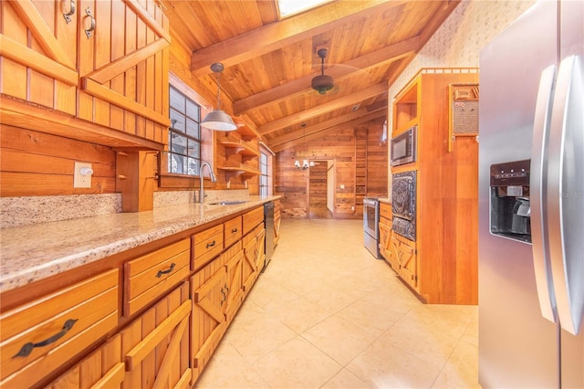 kitchen with wood walls, wood ceiling, light stone counters, appliances with stainless steel finishes, and a sink