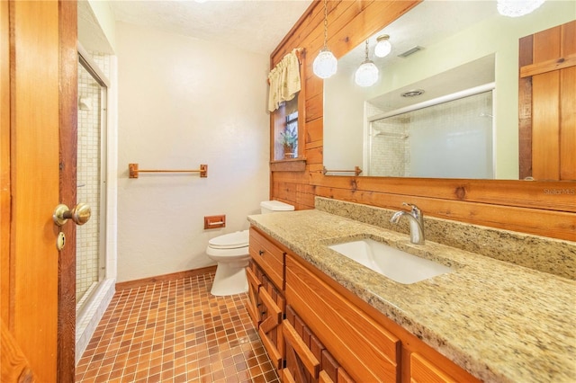 bathroom featuring visible vents, a shower stall, vanity, and toilet