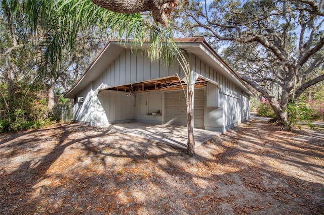 view of side of property with an outbuilding and a detached garage