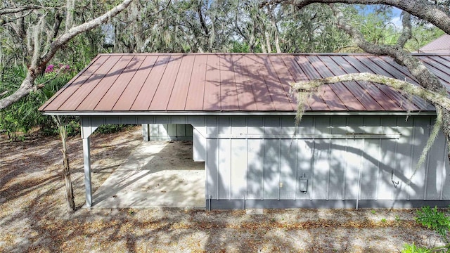 view of side of home with a standing seam roof and metal roof