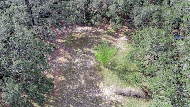 bird's eye view featuring a wooded view