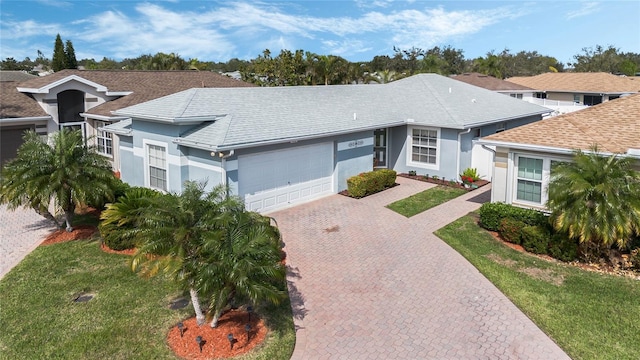 single story home featuring a garage and a front yard