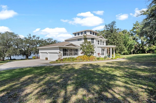 view of front of home featuring a garage and a front yard