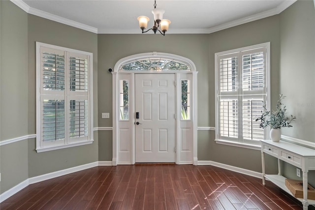 entrance foyer with crown molding, a notable chandelier, and dark hardwood / wood-style flooring