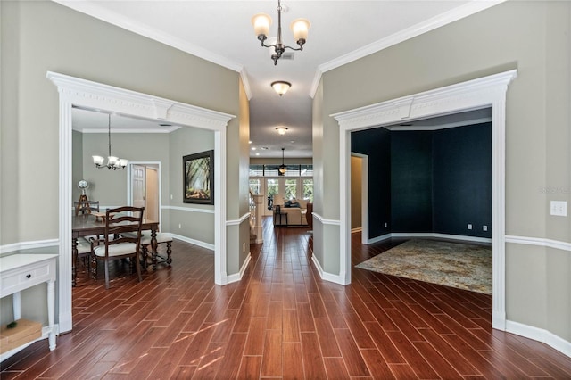 foyer entrance featuring ceiling fan with notable chandelier, ornamental molding, and dark hardwood / wood-style floors