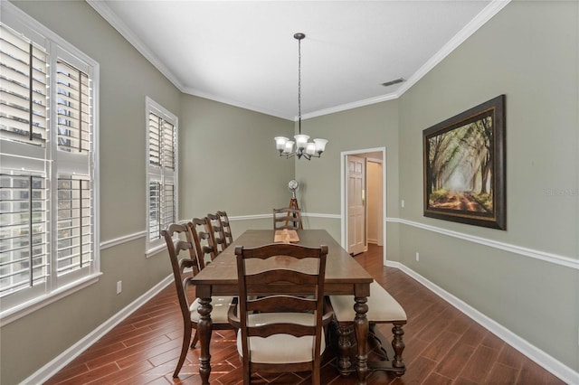 dining space featuring crown molding and a chandelier