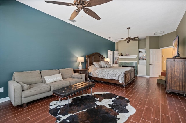 bedroom featuring ceiling fan and a high end fireplace