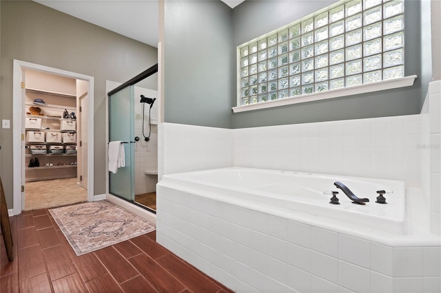 bathroom featuring separate shower and tub