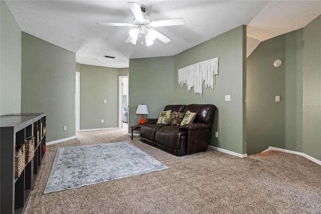 carpeted living room featuring ceiling fan