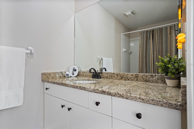 bathroom featuring vanity and a shower with curtain