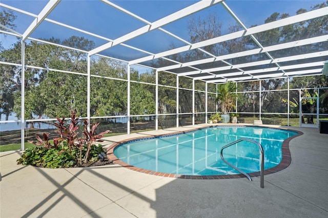 view of pool with a patio and glass enclosure