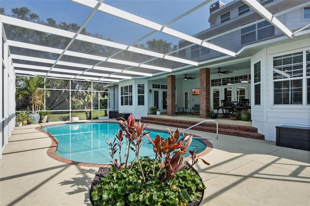 view of swimming pool featuring a patio area, french doors, ceiling fan, and glass enclosure