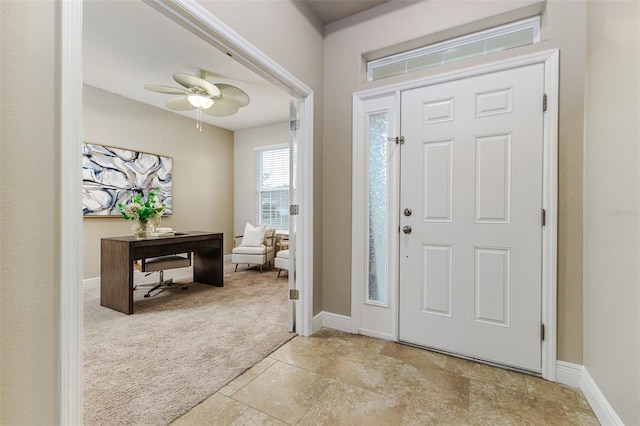 foyer with light carpet and ceiling fan