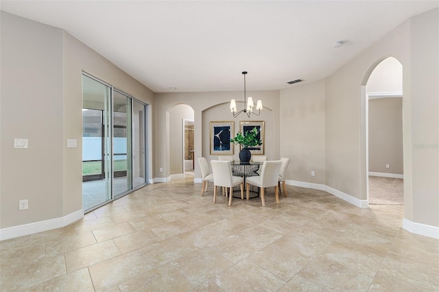 dining space with a chandelier