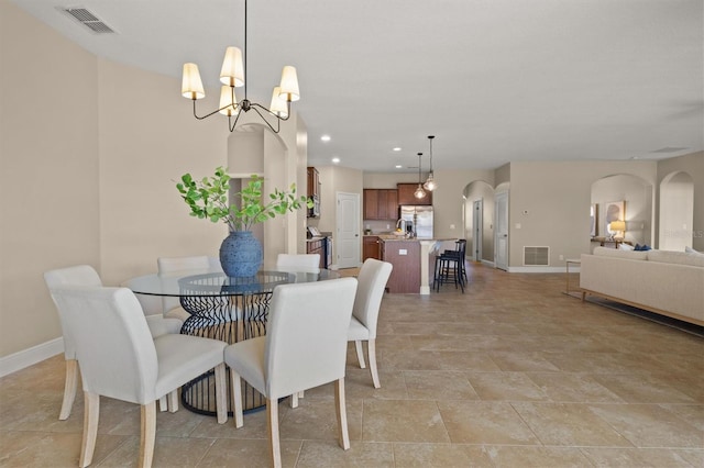 dining space featuring a notable chandelier