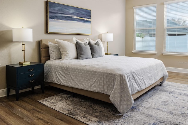 bedroom with dark hardwood / wood-style floors