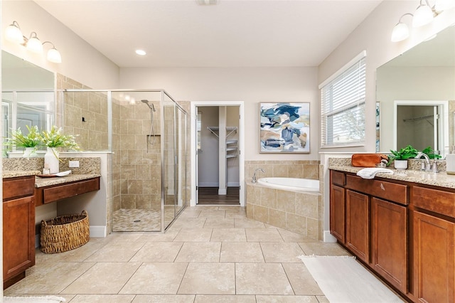 bathroom featuring independent shower and bath, vanity, and tile patterned flooring