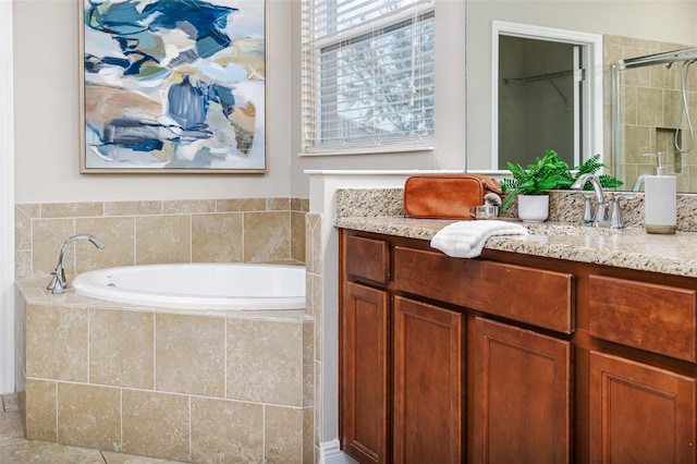 bathroom with vanity and independent shower and bath