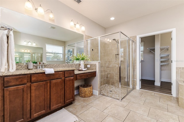 bathroom with vanity, an enclosed shower, and tile patterned floors