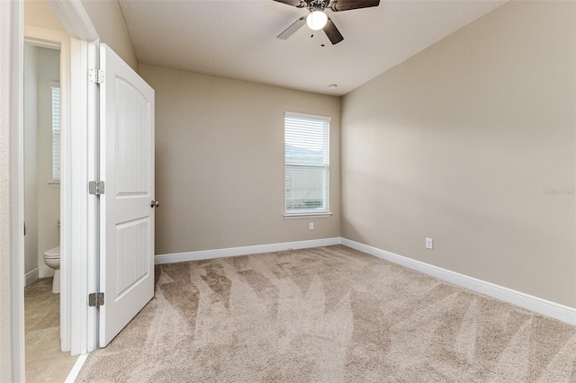 unfurnished bedroom with light colored carpet and ceiling fan