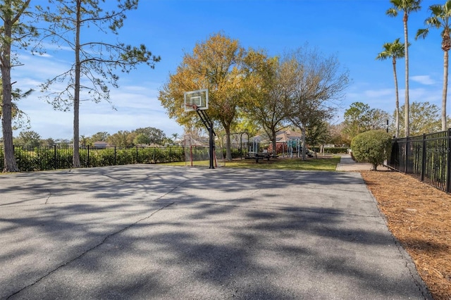 view of basketball court with a playground