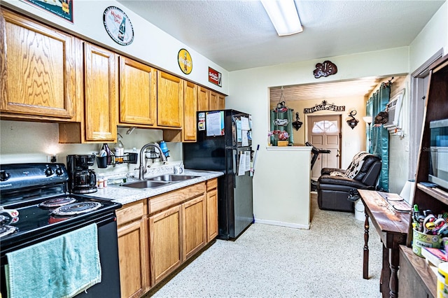 kitchen featuring sink, a textured ceiling, and black appliances