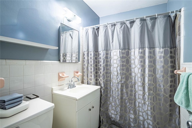 bathroom featuring vanity, toilet, tile walls, and a shower with shower curtain