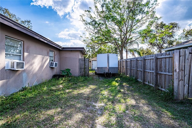 view of yard with cooling unit and a shed