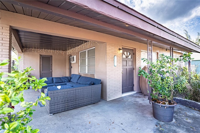 entrance to property featuring an outdoor hangout area and a patio