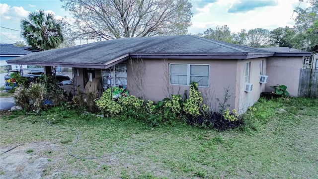 view of front facade with a front lawn and a carport