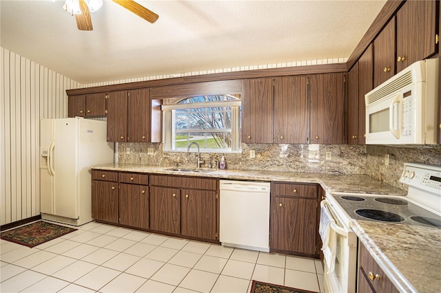 kitchen with sink, decorative backsplash, ceiling fan, dark brown cabinets, and white appliances