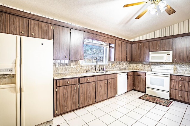 kitchen with white appliances, sink, dark brown cabinets, and a textured ceiling