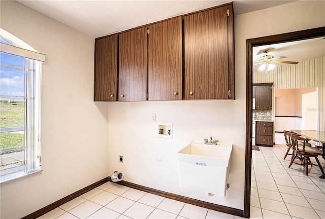 laundry area with sink, cabinets, light tile patterned floors, hookup for a washing machine, and hookup for an electric dryer