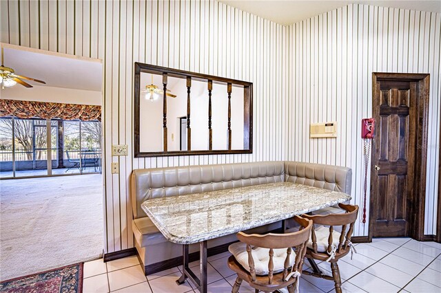 tiled dining room featuring breakfast area and ceiling fan