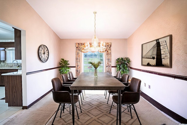 carpeted dining space with sink and a notable chandelier