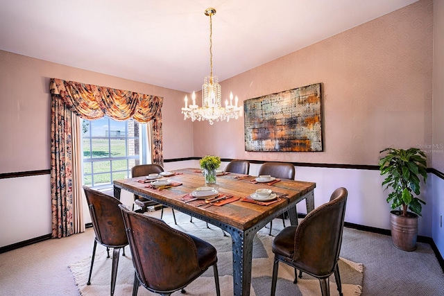 dining space with light colored carpet and a notable chandelier