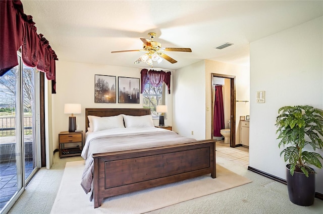 bedroom with light carpet, access to exterior, ceiling fan, and ensuite bathroom