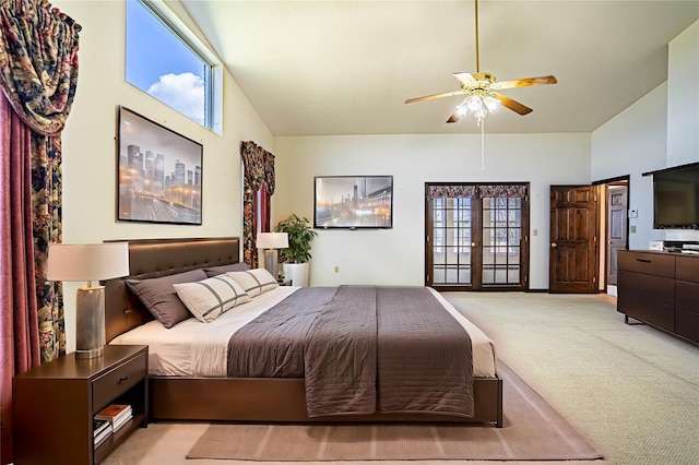 carpeted bedroom with multiple windows, ceiling fan, high vaulted ceiling, and french doors