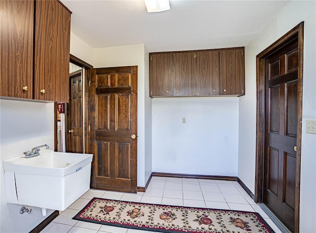 kitchen featuring light tile patterned floors and sink