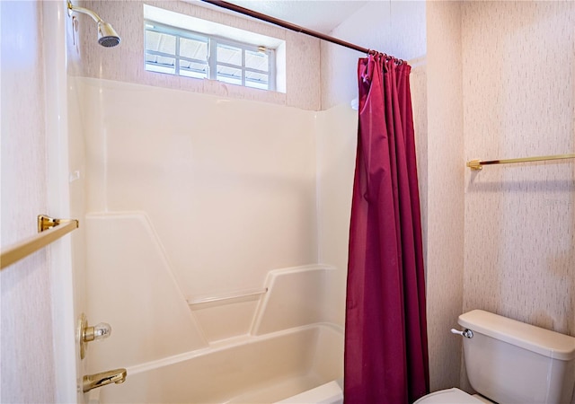 bathroom with shower / tub combo and toilet