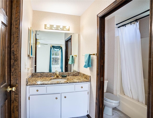 full bathroom with ceiling fan, vanity, toilet, and shower / tub combo