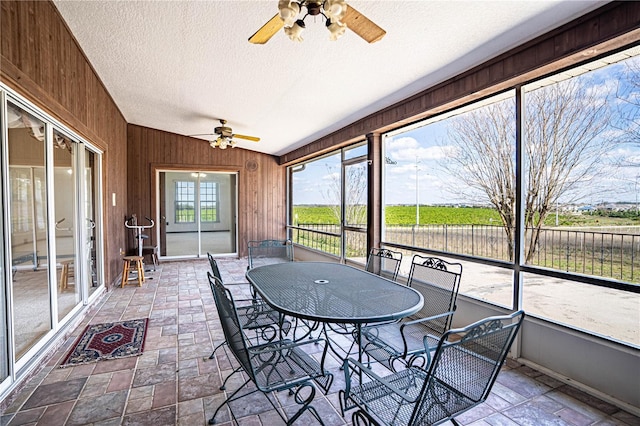 unfurnished sunroom with ceiling fan