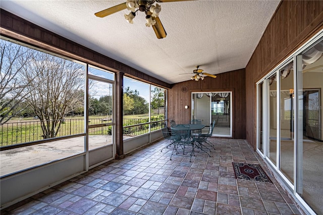 unfurnished sunroom featuring ceiling fan