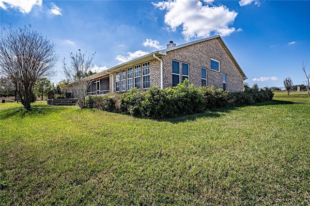 view of side of property with a lawn