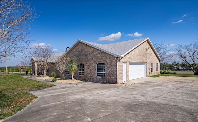 view of home's exterior with a garage and a yard