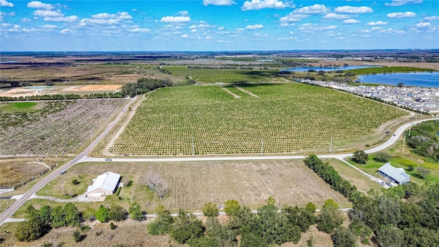 birds eye view of property featuring a water view and a rural view