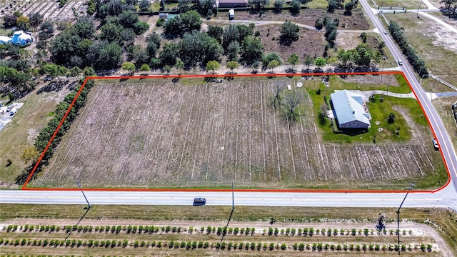 birds eye view of property featuring a rural view