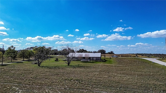 surrounding community with a rural view and a lawn