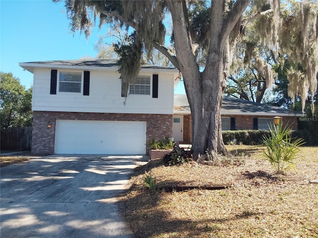 view of front of property featuring brick siding, driveway, and an attached garage