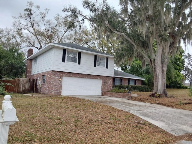 traditional home with a chimney, brick siding, fence, and driveway